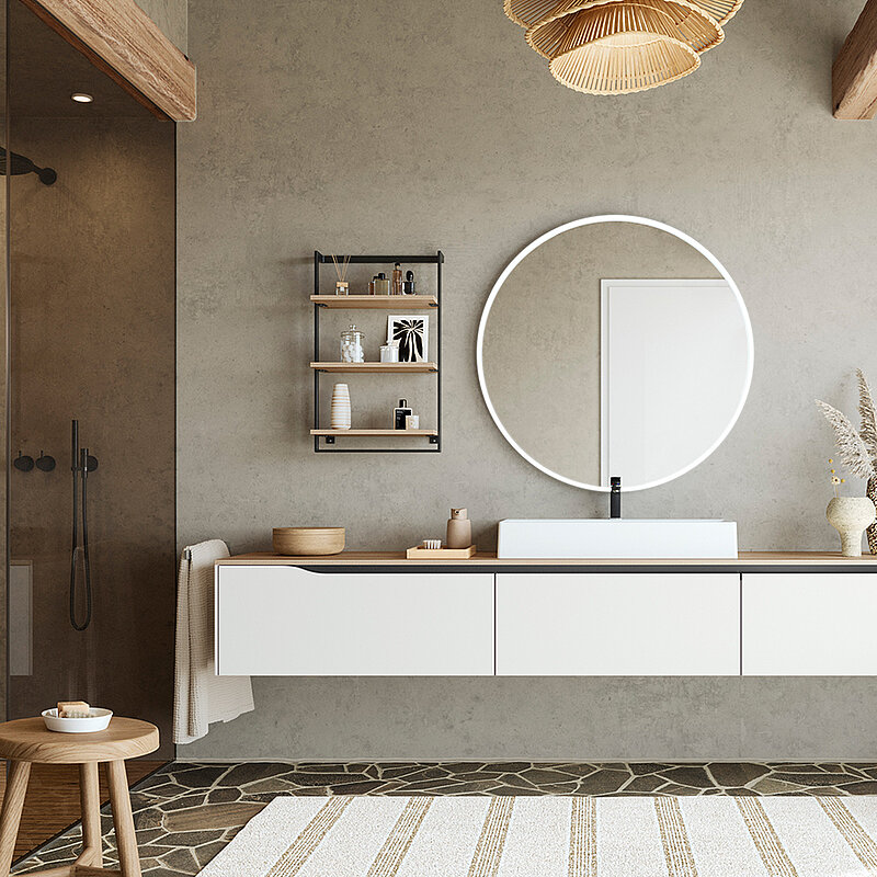 Minimalistisches Badezimmerdesign mit einem schwebenden Waschtisch, einem runden Spiegel und natürlichen Akzenten für einen ruhigen und stilvollen Raum.